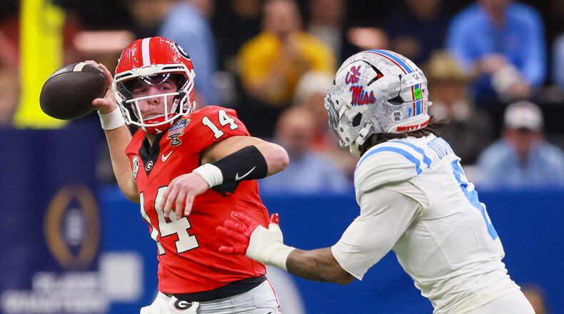 Georgia quarterback Gunner Stockton throws under pressure from Ole Miss linebacker TJ Dottery during the College Football Playoff quarterfinal game Jan. 1, 2026. (Jason Getz/AJC)