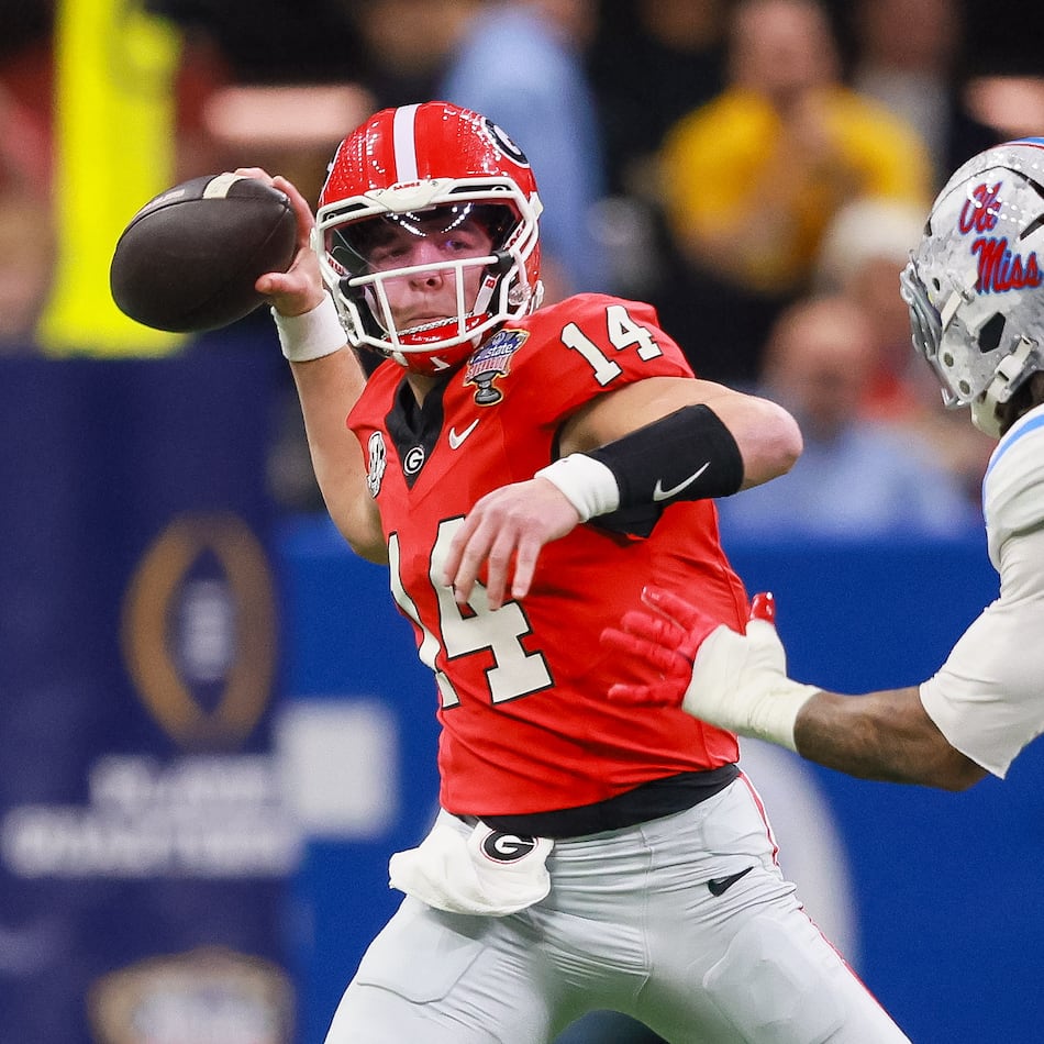 Georgia quarterback Gunner Stockton throws under pressure from Ole Miss linebacker TJ Dottery during the College Football Playoff quarterfinal game Jan. 1, 2026. (Jason Getz/AJC)