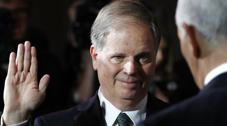 Sen. Doug Jones, D-Ala., listens as Vice President Mike Pence, right, administers the Senate oath of office during a mock swearing in ceremony in the Old Senate Chamber, Wednesday, Jan. 3, 2018 on Capitol Hill in Washington. (AP Photo/Jacquelyn Martin)