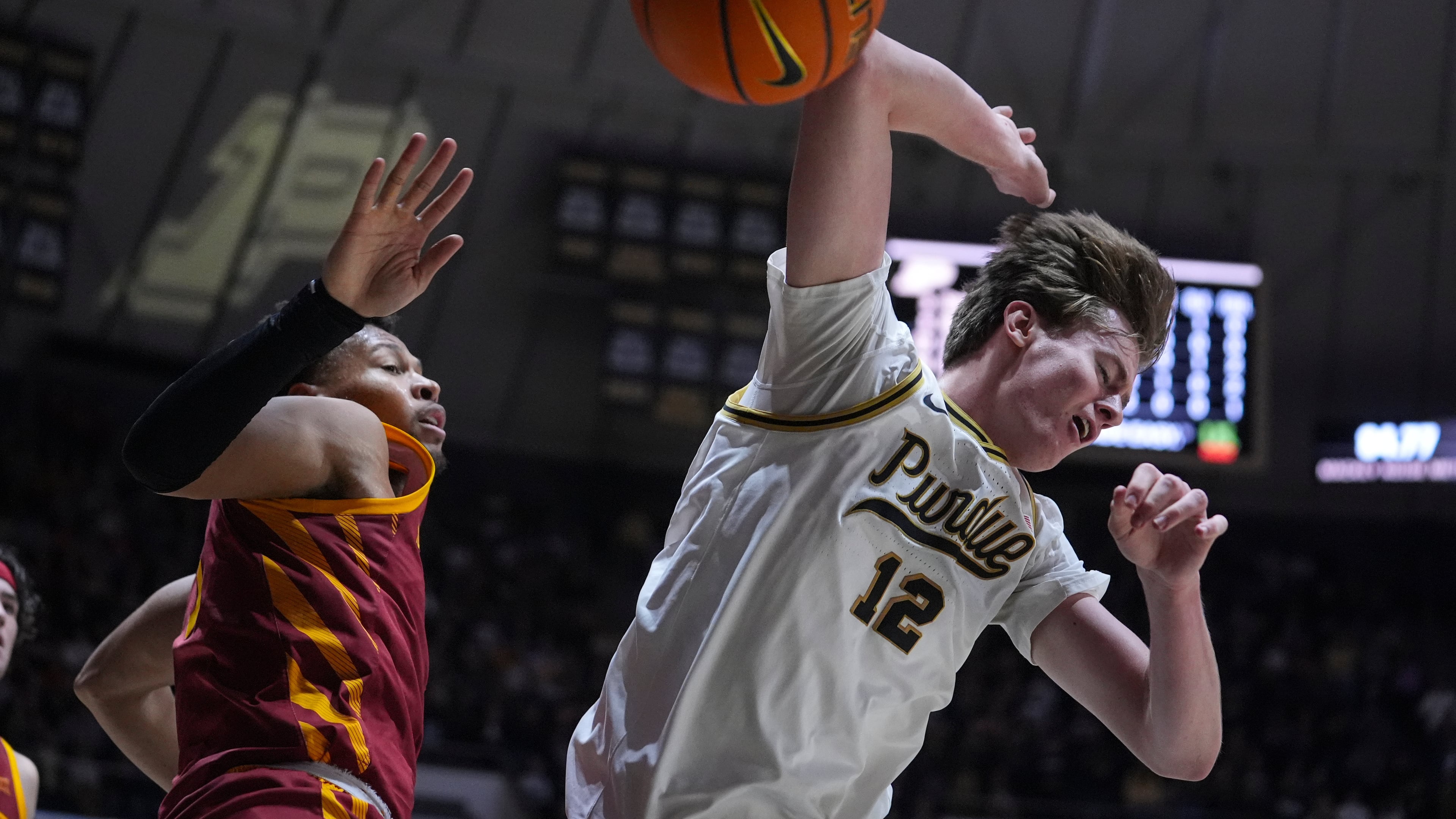 Purdue center Daniel Jacobsen (12) looses the ball after being fouled by Iowa State forward Joshua Jefferson (5) during the second half of an NCAA college basketball game in West Lafayette, Ind., Saturday, Dec. 6, 2025. (AP Photo/Michael Conroy)