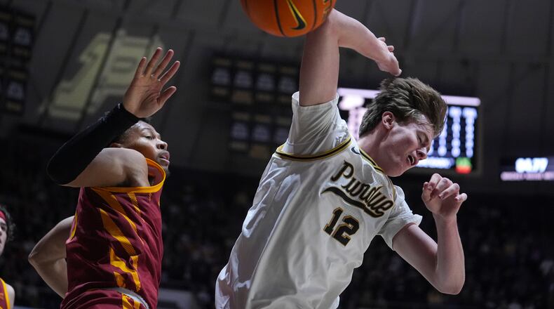 Purdue center Daniel Jacobsen (12) looses the ball after being fouled by Iowa State forward Joshua Jefferson (5) during the second half of an NCAA college basketball game in West Lafayette, Ind., Saturday, Dec. 6, 2025. (AP Photo/Michael Conroy)