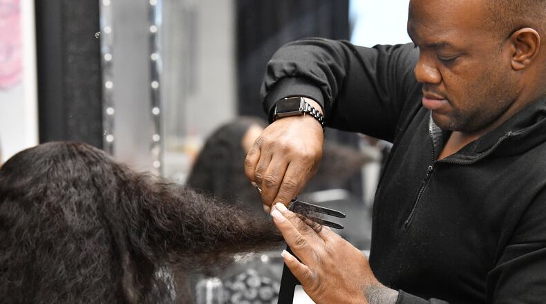 Celebrity hairstylist Derek J. styles his client Miracle Jenkins’ hair at J Spot Hair Salon, Thursday, Feb. 2, 2023, in Buckhead. (Hyosub Shin / Hyosub.Shin@ajc.com)