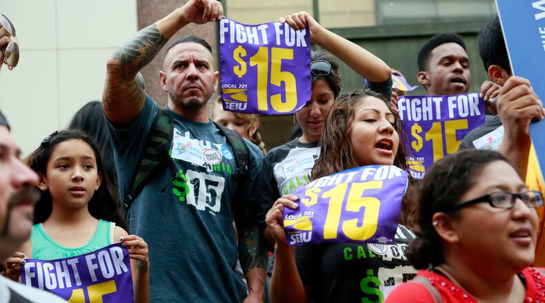In this July 21, 2015, file photo, workers hold a rally in Los Angeles in support of the Los Angeles County Board of Supervisors' proposed minimum wage ordinance. On March 26, California legislators and labor unions reached an agreement that will take the state's minimum wage from $10 to $15 an hour.