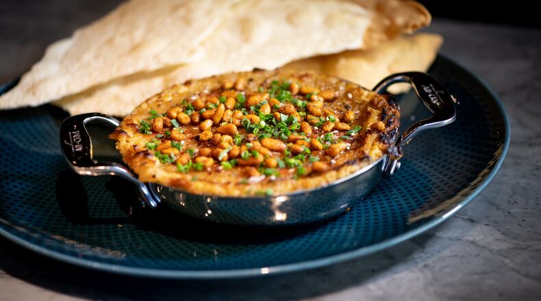 Fia’s wood-fired hummus is served with charred sweet onion, toasted pine nut and lavash crackers. CONTRIBUTED BY MIA YAKEL