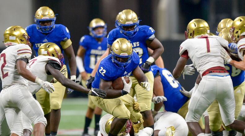 McEachern senior RB Jordon Simmons (22) gains yardage against the Brookwood defense in the second half of their game at the Mercedes Benz Stadium in Atlanta during the Corky Kell Classic Saturday, August 24, 2019. PHOTO/Daniel Varnado