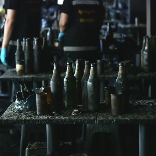 In this handout photo released by Bangkok Metropolitan Administration, bottles are seen on a table at the site of a fire in Bangkok, Thailand, Monday, July 13, 2026. (Bangkok Metropolitan Administration via AP)