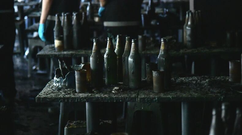 In this handout photo released by Bangkok Metropolitan Administration, bottles are seen on a table at the site of a fire in Bangkok, Thailand, Monday, July 13, 2026. (Bangkok Metropolitan Administration via AP)