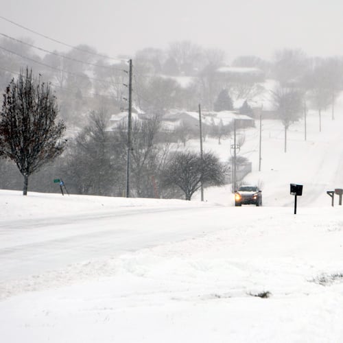 A car drives up a snowy Christy Road in the Sunnybrook neighborhood of Sioux City, Iowa, Saturday, Nov. 29, 2025. (Jared McNett /Sioux City Journal via AP)