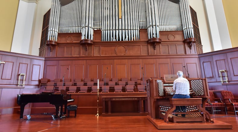 Richard Marchand plays a pipe organ at Johns Creek United Methodist Church that was donated by a Manhattan church that was just blocks away from the World Trade Center when the towers went down. (HYOSUB SHIN / HSHIN@AJC.COM)