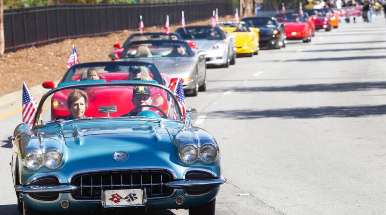 Don Nugent and his wife, Carolyn, lead a long line of flag-bearing Corvettes during the 40th annual Georgia Veterans Day Parade at The Battery in Cobb County on Saturday, November 6, 2021. (Photo: Steve Schaefer for The Atlanta Journal-Constitution)