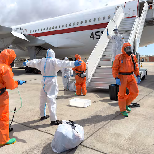 A Spanish passenger is sprayed with disinfectant by Spanish government officials before boarding a plane after disembarking from the hantavirus-stricken cruise ship MV Hondius at Tenerife airport in the Canary Islands, Spain, Sunday, May 10, 2026. (AP Photo)