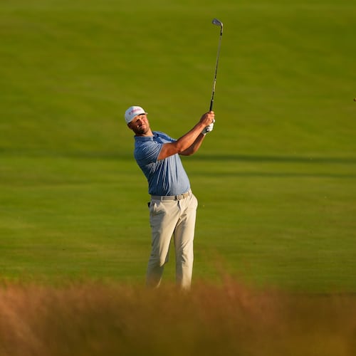 Wyndham Clark hits from the fairway on the third hole during the first round of the U.S. Open golf tournament at Shinnecock Hills Golf Club in Southampton, N.Y., Thursday, June 18, 2026.(AP Photo/David J. Phillip)