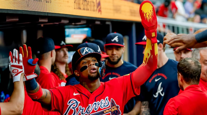 Atlanta Braves' Ronald Acuña Jr., center, is greeted in the dugout after scoring against the Colorado Rockies during the second inning of a baseball game, Friday, Aug. 28, 2026, in Atlanta. (Erik S. Lesser/AP)