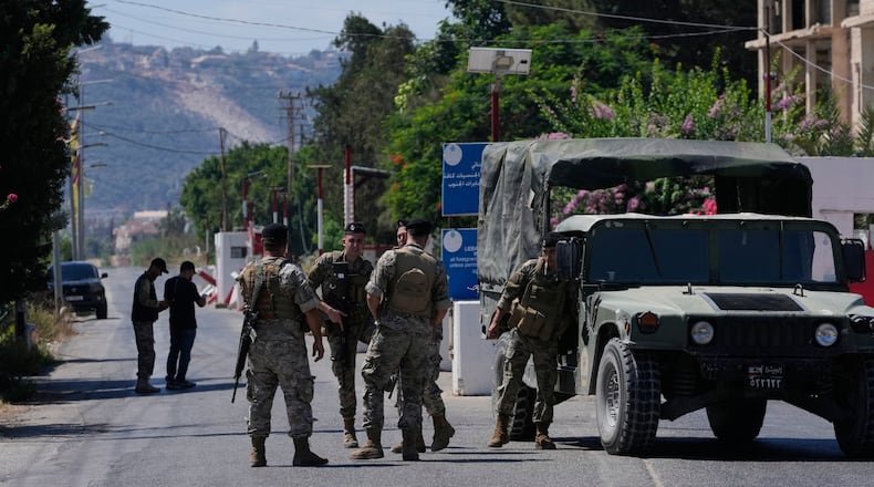 Lebanese army soldiers stand guard at a checkpoint near the border with Israel in the southern village of Mansouri, Lebanon, Friday, Sept. 4, 2026. (AP Photo/Mohammed Zaatari)