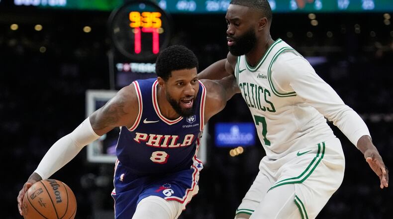 FILE - Philadelphia 76ers forward Paul George (8) drives around Boston Celtics guard Jaylen Brown (7) during the second half in Game 1 of a first-round NBA playoffs basketball game, Sunday, April 19, 2026, in Boston. (AP Photo/Robert F. Bukaty)