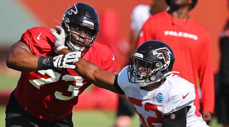 Falcons rookie linebacker Yurik Bethune (right) rushes against tackle Matt Gono (left) on the first day in pads at training camp Wednesday, July 24, 2019, in Flowery Branch.