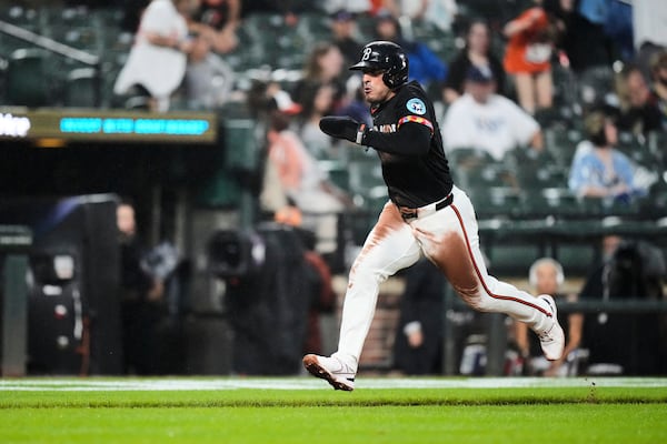 Baltimore Orioles' Ramon Laureano advances toward home plate to score on a throwing error by Tampa Bay Rays catcher Danny Jansen during the third inning of a baseball game, Friday, June 27, 2025, in Baltimore. (AP Photo/Stephanie Scarbrough)