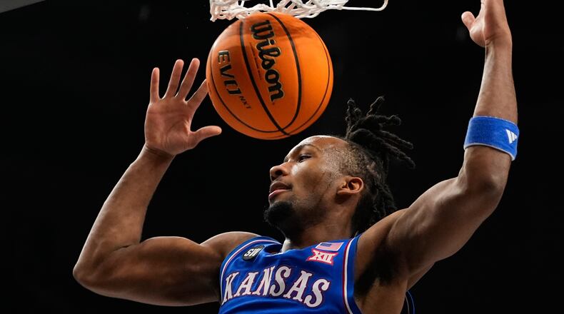 FILE - Kansas' Darryn Peterson dunks during the first half of an NCAA college basketball game against Houston in the semifinal round of the Big 12 Conference tournament March 13, 2026, in Kansas City, Mo. (AP Photo/Charlie Riedel, File)