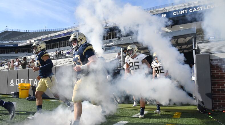 March 17, 2022 Atlanta - Georgia Tech players run onto the football field during the 2022 Spring Game at Georgia Tech's Bobby Dodd Stadium in Atlanta on Thursday, March 17, 2022. (Hyosub Shin / Hyosub.Shin@ajc.com)