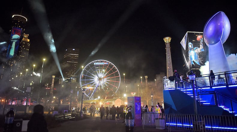 Atlanta’s Centennial Olympic Park was full of lights on the opening night of Super Bowl Live. The fan village is part of the activities and marketing bonanza leading up to the game. But trademark laws and past actions by the NFL have made some Georgia companies wary of using the Super Bowl name. RYON HORNE / RHORNE@AJC.COM