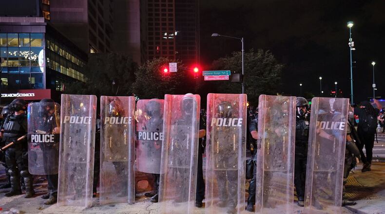After a peaceful march, a protest turned violent Friday night. Some protesters returned to the area around Centennial Olympic Park and CNN Center where some confronted police, who sprayed some demonstrators with pepper spray.