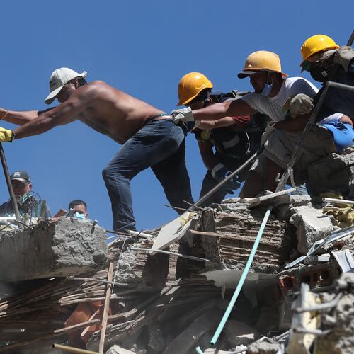 Residents and rescue workers search through the rubble after an earthquake struck Cali, Colombia, Monday, Aug. 10, 2026. (AP Photo/Santiago Saldarriaga)