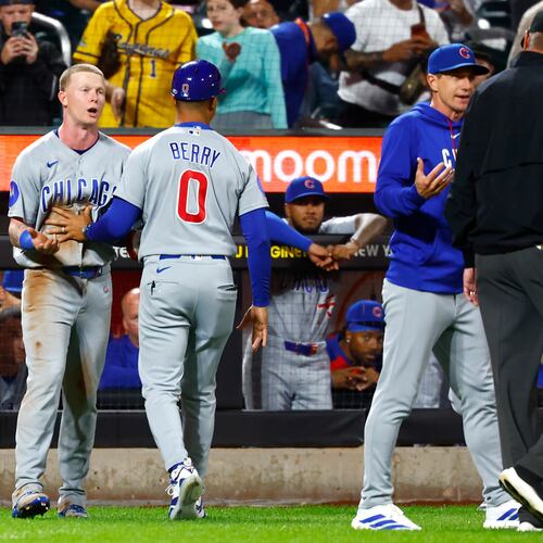 Chicago Cubs' center fielder Pete Crow-Armstrong, left, and manager Craig Counsell, right, argue with umpire Jordan Baker (71) during the seventh inning of a baseball game against the New York Mets, Tuesday, June 23, 2026, in New York. (AP Photo/Noah K. Murray)