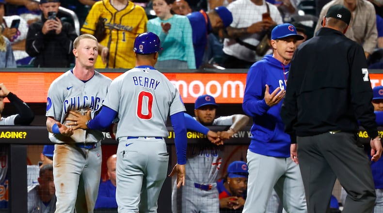 Chicago Cubs' center fielder Pete Crow-Armstrong, left, and manager Craig Counsell, right, argue with umpire Jordan Baker (71) during the seventh inning of a baseball game against the New York Mets, Tuesday, June 23, 2026, in New York. (AP Photo/Noah K. Murray)