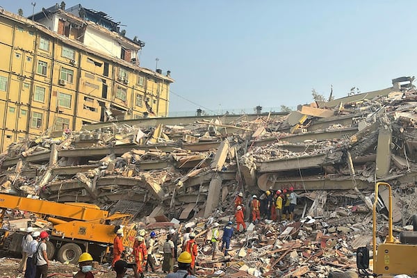 Rescuers work in a building that collapsed In Friday's earthquake in Mandalay, Myanmar, Sunday, March 30, 2025. (AP Photo/Thein Zaw)