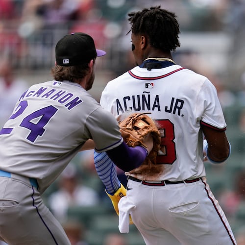 Colorado Rockies third baseman Ryan McMahon (24) tags Atlanta Braves outfielder Ronald Acuña Jr. (13) out near home plate in the sixth inning of a baseball game, Sunday, June 15, 2025, in Atlanta. (AP Photo/Mike Stewart)