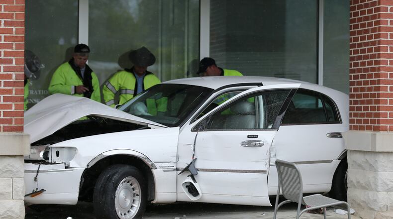 Police investigate the scene where an 81-year-old driver lost control of her car outside of the Paulding County Courthouse on Friday afternoon. The woman hit three adults, one of whom was carrying 5-month-old twins. One woman was killed in the incident, though the infants were not hurt. BEN GRAY / BGRAY@AJC.COM