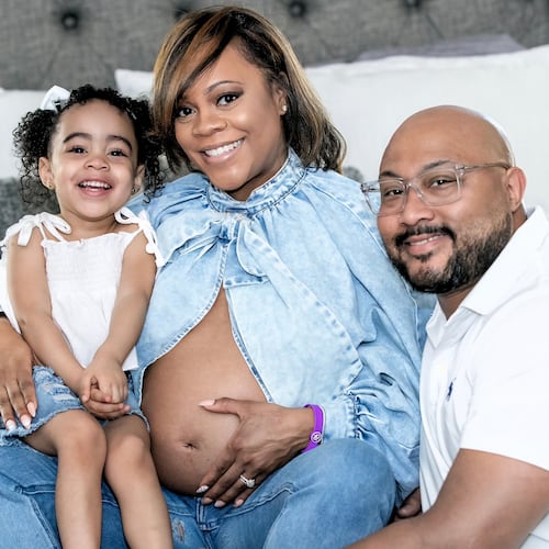 Metria Cauthen shows off her baby bump (and her birth alert bracelet) with husband, Armand Cauthen, and 3-year-old daughter, Autumn. (Aaron Moon/Courtesy Wellstar Cobb Medical Center)