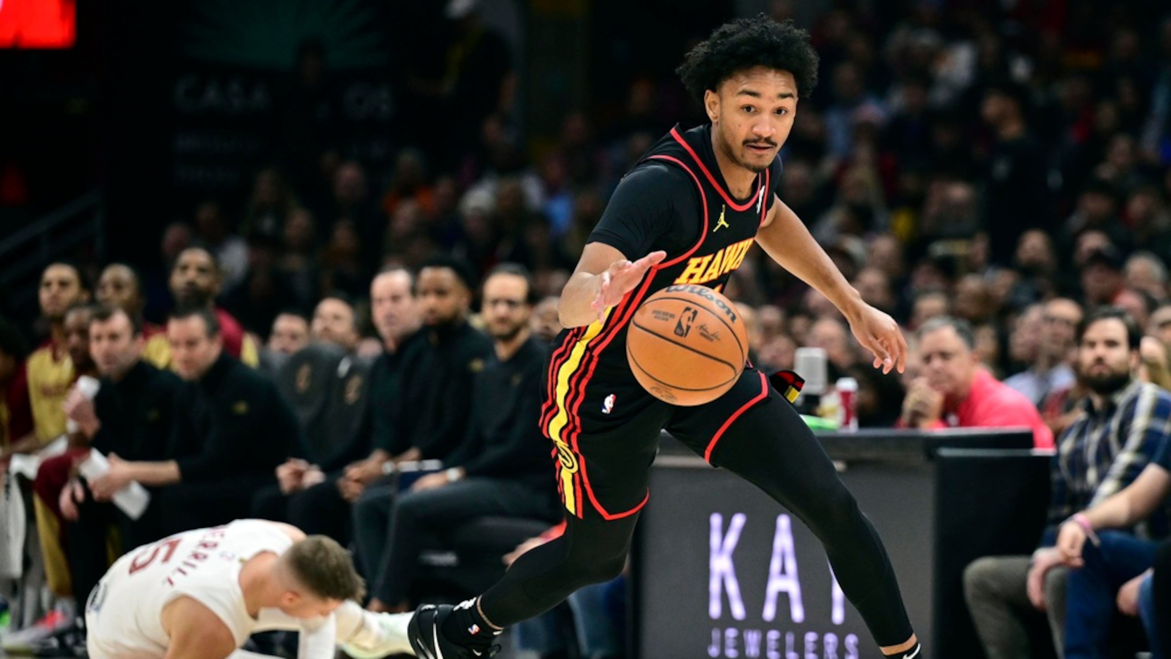 Atlanta Hawks guard Kobe Bufkin dribbles away from Cleveland Cavaliers guard Sam Merrill in the first half of an NBA basketball game, Wednesday, Nov. 23, 2024, in Cleveland. (David Dermer/AP)