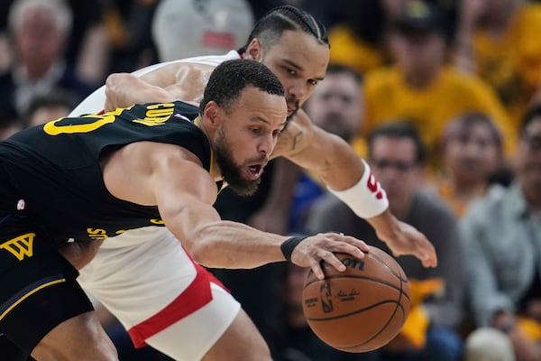 Golden State Warriors guard Stephen Curry, left, takes the ball away from Houston Rockets forward Dillon Brooks during the first half of Game 6 of an NBA basketball first-round playoff series Friday, May 2, 2025, in San Francisco. (AP Photo/Godofredo A. Vásquez)