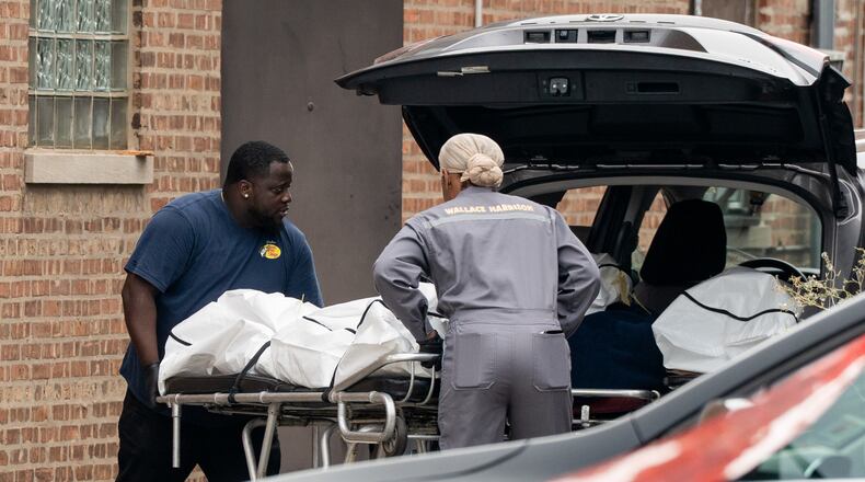 Workers load bodies into an SUV outside South Chicago Chapel on Friday, Aug. 7, 2026, after authorities found more than 50 bodies improperly stored at the funeral home during an investigation the previous night in Chicago. (Pat Nabong /Chicago Sun-Times via AP)