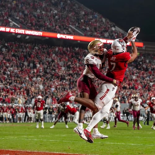 N.C. State tight end Justin Joly (7) soars to make a catch over Florida State defensive back Shamar Arnoux (15) in the second half of a NCAA football game on Nov. 21, 2025. (David Yeazell/AP)