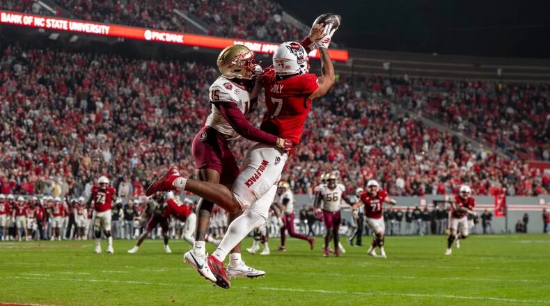 N.C. State tight end Justin Joly (7) soars to make a catch over Florida State defensive back Shamar Arnoux (15) in the second half of a NCAA football game on Nov. 21, 2025. (David Yeazell/AP)