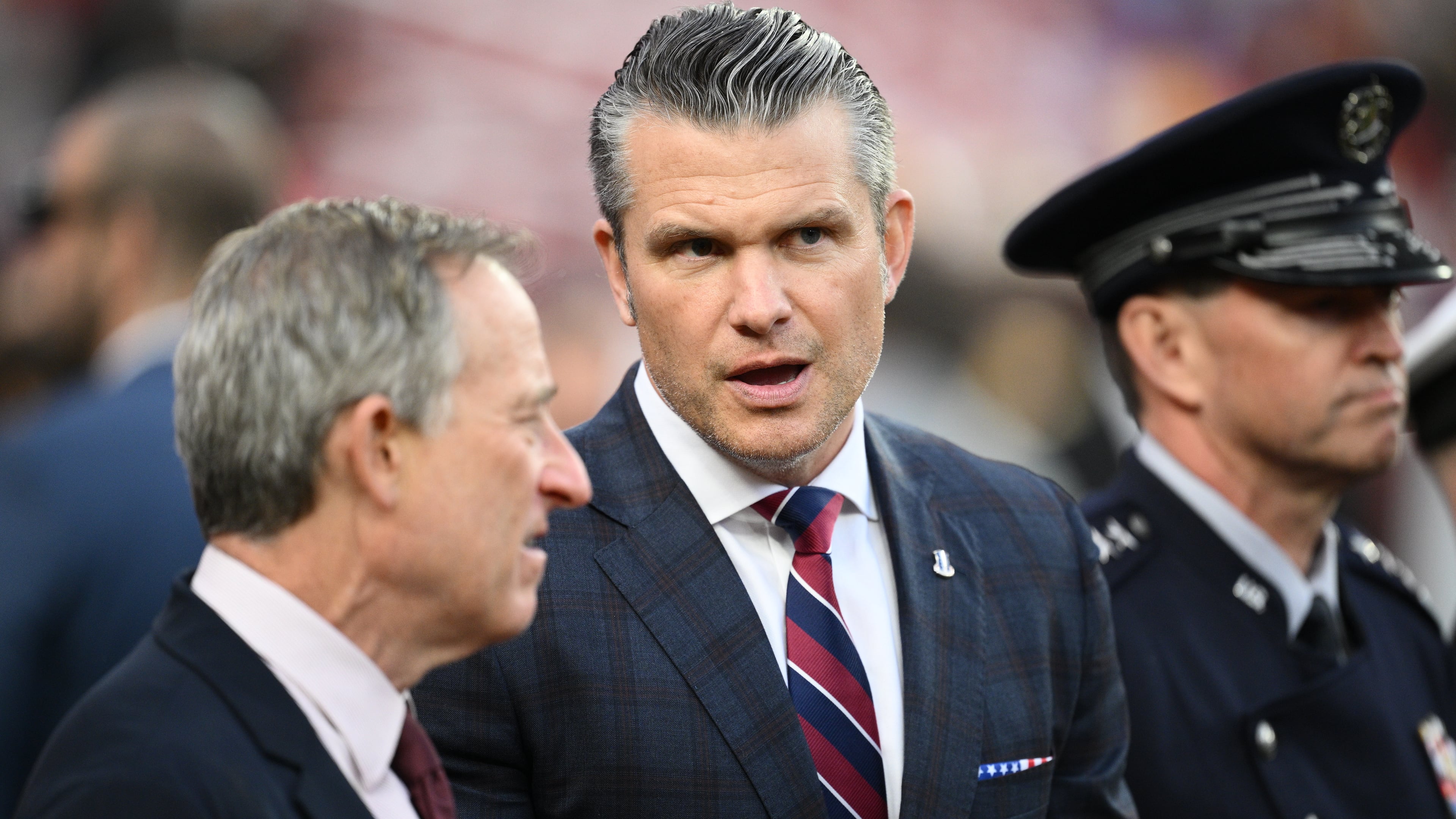 Defense Secretary Pete Hegseth is seen on the sidelines before an NFL football game between the Washington Commanders and the Detroit Lions Sunday, Nov. 9, 2025, in Landover, Md. (AP Photo/Nick Wass)