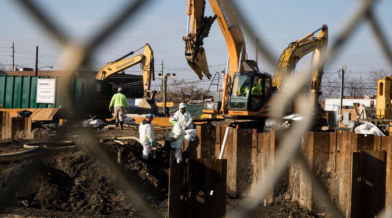 FILE - People in protective clothing work at the Martin Aaron Inc. Superfund site in Camden, N.J, Dec. 11, 2017. (AP Photo/Matt Rourke, File)