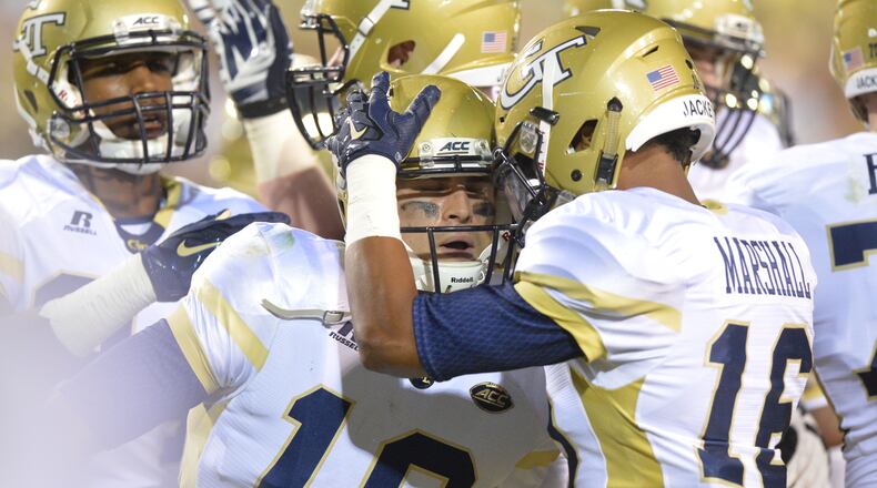 Georgia Tech quarterback Tim Byerly (18) and teammates celebrate after he scored a touchdown in the first half of the Tech season opener at Bobby Dodd Stadium on Thursday, September 3, 2015. HYOSUB SHIN / HSHIN@AJC.COM