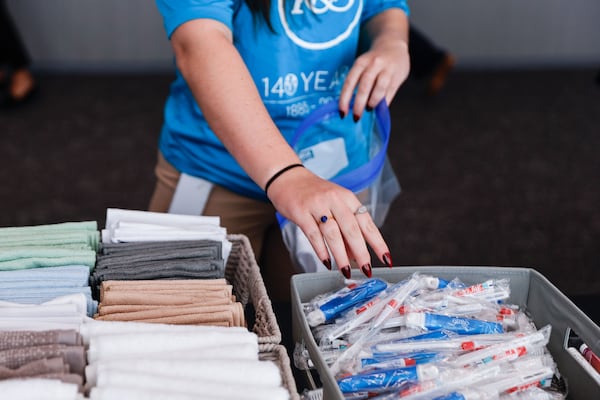 A King & Spalding employee creates a hygiene kit for a local nonprofit at the law firm's Atlanta office on Oct. 14, 2025. (Natrice Miller/AJC)