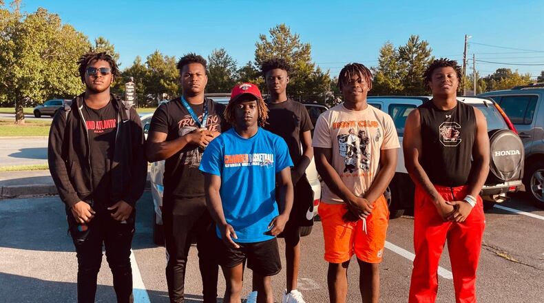Rome High School football players Cesar Parker (from left), Treyvon Adams, Antwiion Carey, Messiah Daniels, Tyson Brown and Alto Moore rushed to the aid of a motorist involved in a wreck Friday morning in front of the school. (Courtesy of Rome City Schools)