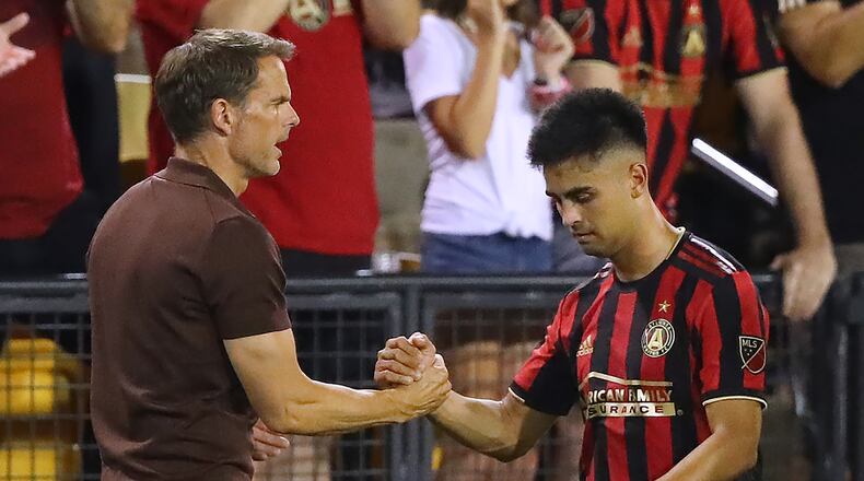 Atlanta United midfielder Pity Martinez gets five from head coach Frank de Boer during a 2-0 victory over St. Louis in a U.S. Open Cup quarterfinals soccer match on Wednesday, July 10, 2019, in Kennesaw. Martinez scored Atlanta United’s first goal in the game. Curtis Compton/ccompton@ajc.com