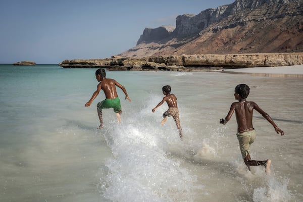 Children play in the waves on the Yemeni island of Socotra on Sept. 22, 2024. (AP Photo/Annika Hammerschlag)