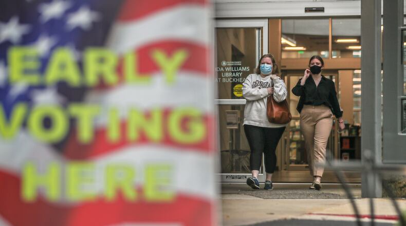Kimberly Underwood (left) and sister, Mary Wallace Underwood leave the Buckhead Library in Atlanta after voting on Tuesday, Oct. 12, 2021 as early voting locations opened (John Spink / John.Spink@ajc.com)