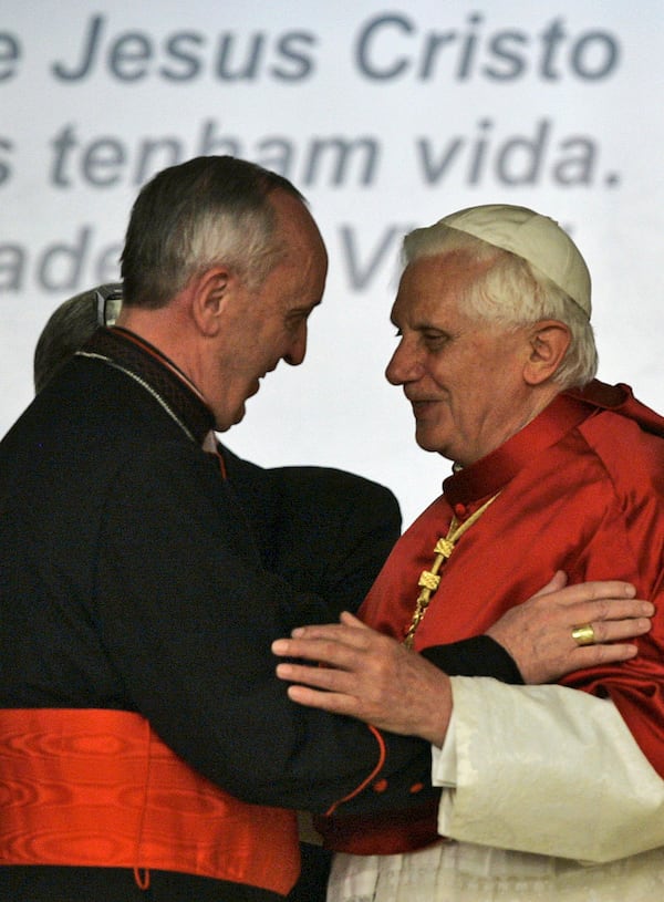 FILE - Pope Benedict XVI, right, embraces Cardinal Jorge Bergoglio, Archbishop of Buenos Aires, during a conference of Latin American and Caribbean bishops in Aparecida, Brazil, May 13, 2007. (AP Photo/Ricardo Mazalan, File)