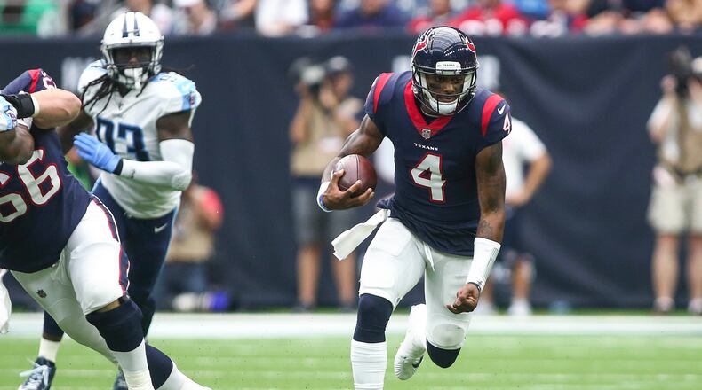 Houston Texans quarterback Deshaun Watson (4) runs with the ball during the first quarter against the Tennessee Titans at NRG Stadium.