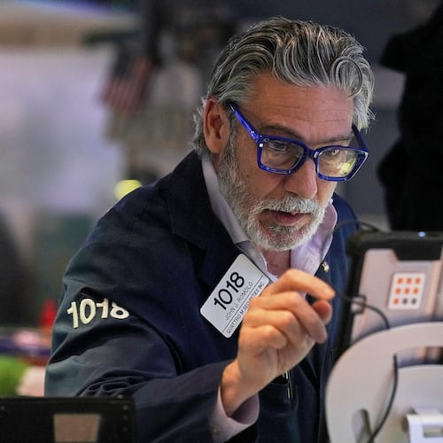 Trader John Romolo works on the floor of the New York Stock Exchange, Monday, Jan. 12, 2026. (AP Photo/Richard Drew)