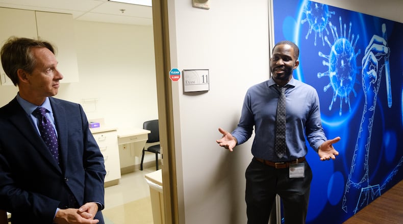 Jared O’Neal, clinical studies director of RADx research at Emory University, (right) leads a tour of the new COVID-19 test research facility in Brookhaven on Wednesday, April 27, 2022. He’s joined by Dr. Greg Martin, co-director of the research center. (Arvin Temkar / arvin.temkar@ajc.com)