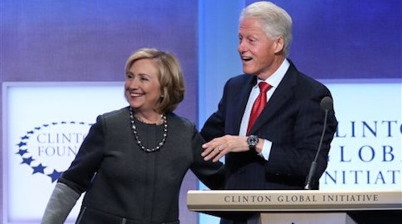 Former Secretary of State Hillary Rodham Clinton and former U.S. President Bill Clinton appear together on stage during a plenary session at the Clinton Global Initiative, Monday, Sept. 22, 2014 in New York. (Photo by Greg Allen/Invision/AP)